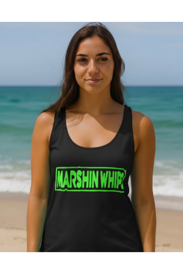 Woman wearing a black tank top and pink beanie with 'Marshin Whips' branding on a beach.